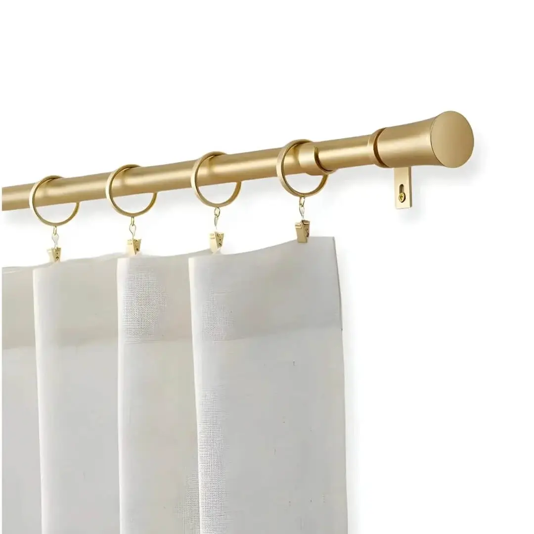 gold curtain rod gold curtain rod - Stylish flowing curtains on a gold curtain rod, installed on a window —creating a chic, inviting ambiance.