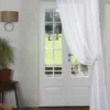 curtain pole for window close to wall curtain rods for windows close to wall - Elegant floor-length curtains hanging on a matte black curtain rod mounted on a wall-adjacent door. Showcases space-saving design with sturdy brackets and seamless fabric drape