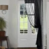curtain pole next to wall curtain rod next to wall - Elegant floor-length curtains hanging on a matte black curtain rod mounted on a wall-adjacent door. Showcases space-saving design with sturdy brackets and seamless fabric drape