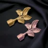 leaf finial for curtain rod Side-by-side comparison of two decorative leaf finials for curtain rods: one in a classic gold finish and the other in a modern rose gold finish.