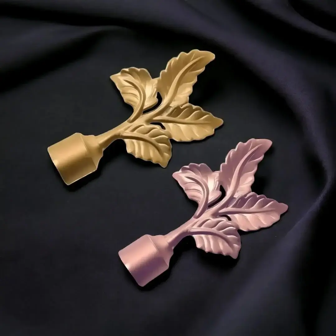 leaf finial for curtain rod Side-by-side comparison of two decorative leaf finials for curtain rods: one in a classic gold finish and the other in a modern rose gold finish.