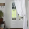 curtain rod next to wall curtain rod next to wall - Elegant floor-length curtains hanging on a matte black curtain rod mounted on a wall-adjacent door. Showcases space-saving design with sturdy brackets and seamless fabric drape