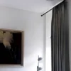 curtain rods for windows close to wall curtain rods for windows close to wall - Elegant floor-length curtains hanging on a matte black curtain rod mounted on a wall-adjacent door. Showcases space-saving design with sturdy brackets and seamless fabric drape
