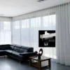 curtain track for living room curtain hanging from a curtain track which is installed on a living room window, creating a chick and inviting ambience.