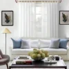 adjustable window curtain rod set adjustable window curtain rod set - Stylish living room with flowing curtains on a 12 feet long gold curtain rod installed on a window, paired with a cozy sofa set, vibrant cushions, and wall paintings—creating a chic, inviting ambiance.