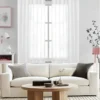 curtain rod for living hall curtain rod for living hall - Stylish living room with flowing voile curtains on a rose gold curtain rod, paired with a cozy sofa set, vibrant cushions, and wall paintings—creating a chic, inviting ambiance
