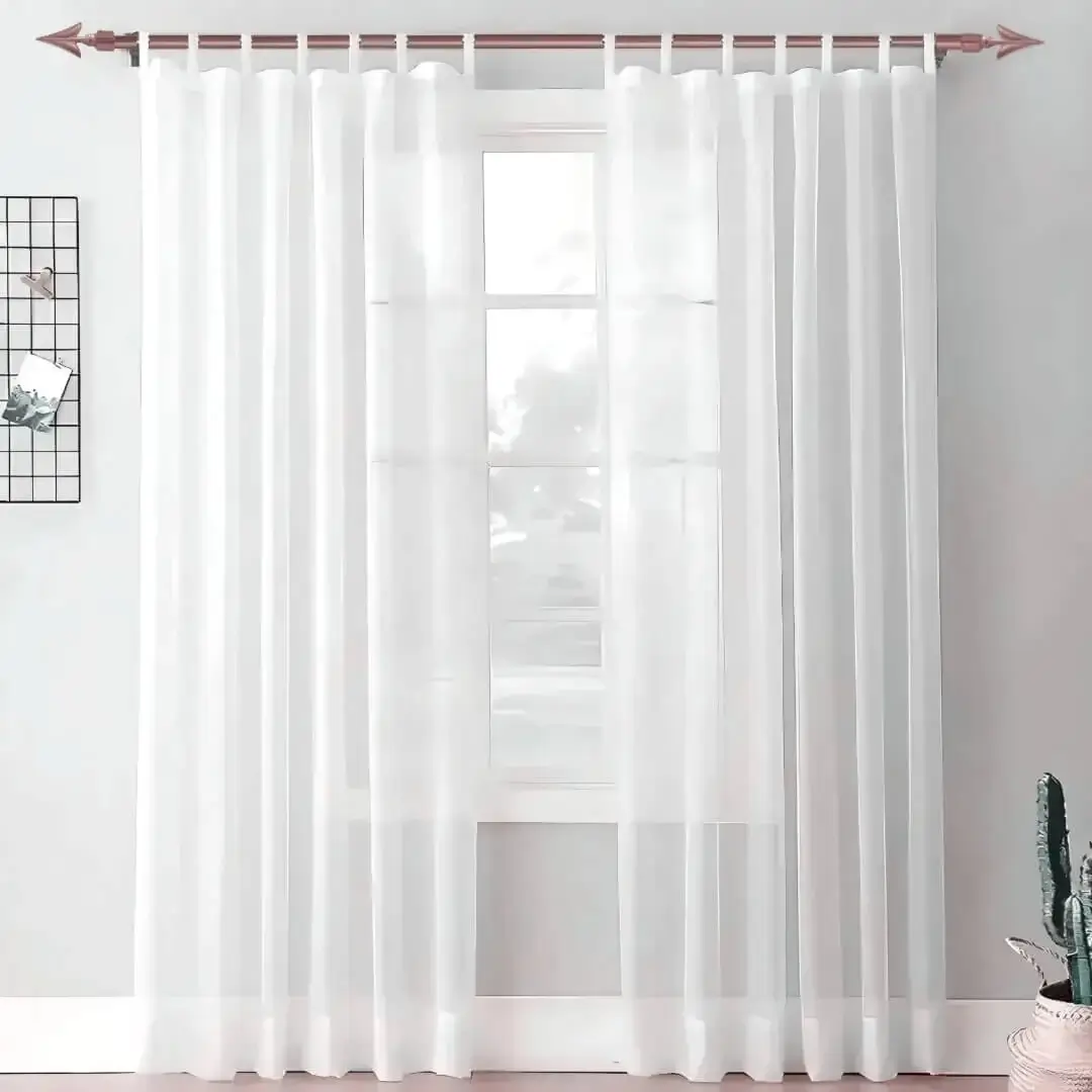 pink gold curtain rod for living room pink gold curtain rod for living room - Elegant white floor-length sheer curtains hanging from a sleek rose curtain rod installed on a window—creating a modern, flowing look while maintaining privacy and natural light