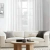 100 inch curtain rod 100 inch curtain rod - Stylish living room with flowing curtains on a 100 inch adjustable curtain rod rose gold colour, paired with a cozy sofa set, vibrant cushions, and wall paintings—creating a chic, inviting ambiance. Text highlight '100 inch'