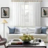150 inch curtain rod set Stylish living room with flowing grommet curtains on adjustable curtain rod, paired with a cozy sofa set, vibrant cushions, and wall paintings—creating a chic, inviting ambiance